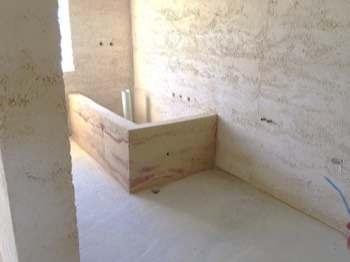  That is one BIG (and beautiful) rammed earth bath!  